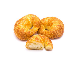 Two fresh baked French butter croissant with cutout piece isolated on white