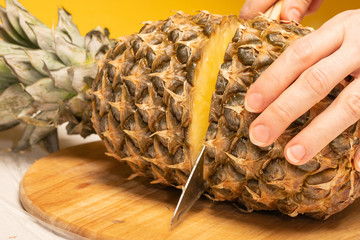 Pineapple fruit cut on wooden board isolated