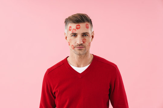 Portrait of handsome man with kiss marks at his face on valentines day