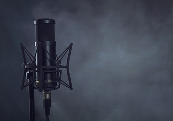 Condenser microphone on a gray grunge background with copy space for titles