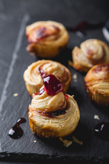 Obraz na płótnie Canvas Small puff pastry rolls with cherry jam
