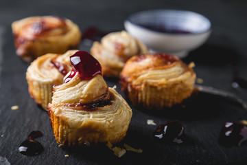 Small puff pastry rolls with cherry jam
