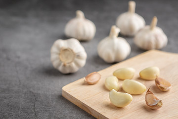Garlic on the black cement floor. High angle view.