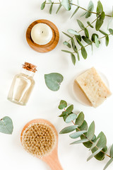 Spa concept with eucalyptus oil and eucalyptus leaf extract natural /organic spa cosmetics products, eco friendly bathroom accessories. Skincare concept on white background. Flat lay composition 