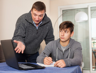 Father scolds his son for bad schooling