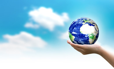 Woman hands holding world or globe on earth day.Environment conservation and energy saving concept.Elements of this image are furnished by NASA.