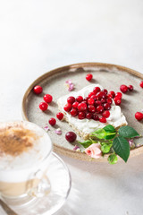 Heart shaped cappuccino and cheese sandwich with red berries.The idea for a festive breakfast, Valentine's Day.