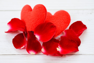 rose petals and heart on white wooden background - flower red rose petals for valentine day concept