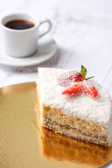Tasty piece of sweet strawberry cake with red berries on cup of coffee americano, white background. Homemade delicious organic dessert sugarless. Healthy eating.