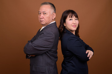 Mature Asian businessman and mature Asian businesswoman together