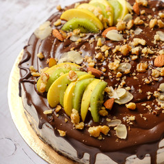 Homemade delicious sweet cake with fruits, chocolate, apple, kiwi on cup of coffee americano, white background. Organic dessert sugarless. Healthy eating.