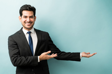 Happy Businessman Doing Advertisement In Studio