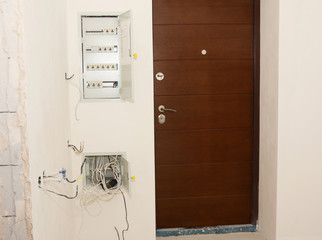 House entrance door with surface mounted open electric meter box with residual current device or RCD