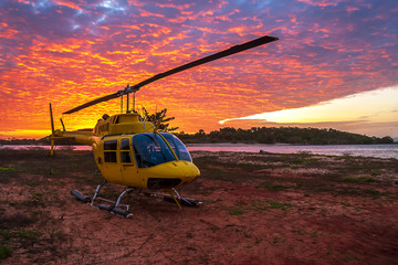 Helicopter on the land next to the sea at sunset, Australia, Northern Territory, Seisia Cape York © Natalie