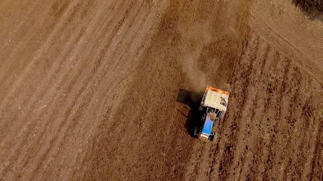 Aerial view of working tractor in agriculture land