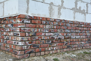 Mineral efflorescence on brick house foundation wall. Efflorescence salt as an indicator of...