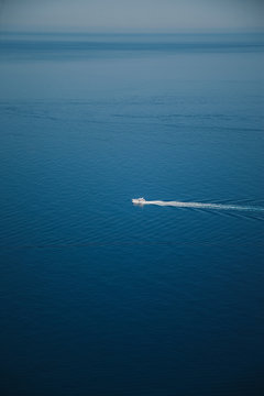 Coast of Majorca. in the middle a small, white yacht on the calm sea. summer scenery. © Lukasz