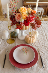 Table set with decor flowers and pumpkin on table