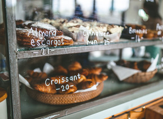 Fresh croissants at bakery display shelf