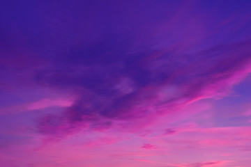 Colorful clouds in summer evening sky. Bright and pink clouds in sky sunset or sunrise. Beautiful purple pink evening sky background.
