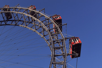 Vienna, Austria, old ferris wheel in Prater park. Fragment of a ferris wheel against the blue...