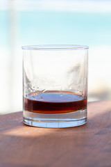 Glass of spiced dark Caribbean rum, vertical close up