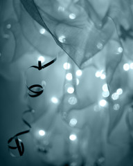 Abstract New Year decoration with ribbons and defocused lights in blue colors