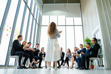 Rear view of Business colleagues discussing report at modern office. Business People applauding while in meeting at office, The Secret to successful business concept