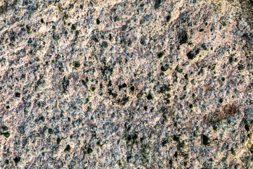 Stone background, rock wall backdrop with rough texture. Abstract, grungy and textured surface of stone material. Nature detail of rocks.