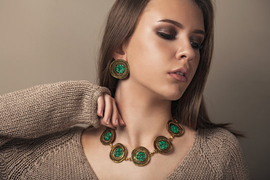 Teen Model With Elegant Jewelery On Brown Background