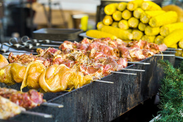 Grilling meat and sweet corn on Christmas holiday market