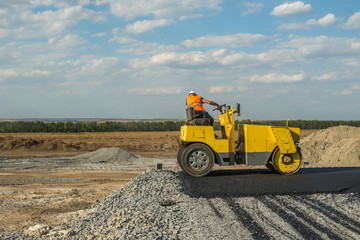 Obraz premium rural road building tractor and vehicle