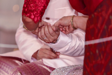 Tie the wrist of the groom in the Thai wedding ceremony.