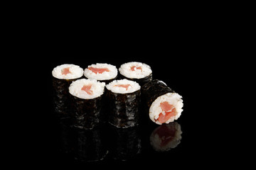 delicious sushi maki with tuna isolated on black
