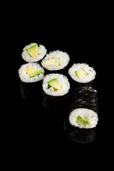 delicious sushi maki with avocado isolated on black