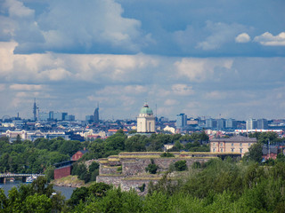 Fototapeta na wymiar Suomenlinna on the foreground and Helsinki skyline on the background seen from Vallisaari. 
