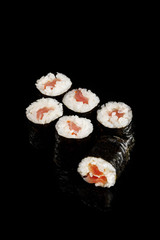 delicious sushi maki with tuna isolated on black