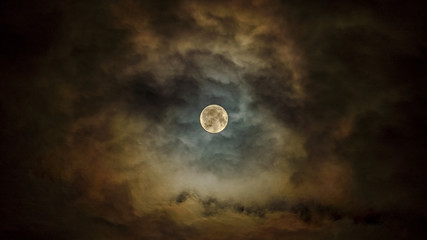 Naklejka na ściany i meble Bright full moon in the cloudy sky