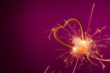 Sparkler love heart shape burning with many spakrs