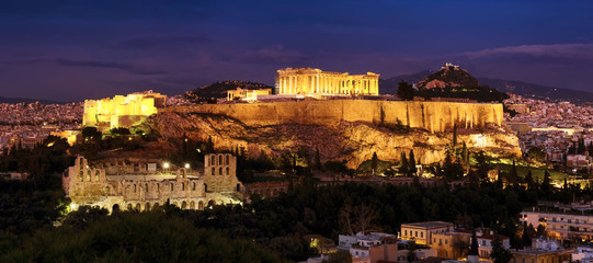 Panorama of Athens with Acropolis hill at dramatic sunset.