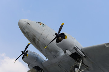 Old military propeller airplane with blue sky