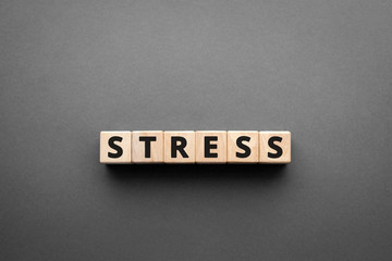 Stress - words from wooden blocks with letters, feel worried and nervous stress concept, top view...