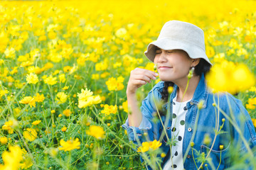 Portrait of a woman standing in yellow flower field