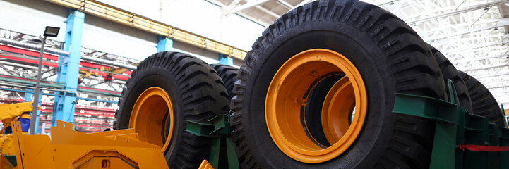 Set of extremely big wheels standing at warehouse of machine building plant