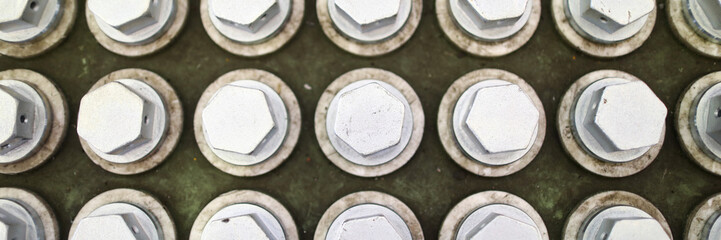 Pile of bolts in special box at industrial plant closeup