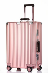 Rose gold suitcase against a black background