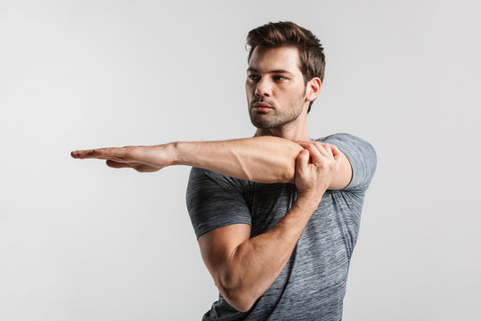 Image of young athletic man doing exercise while working out