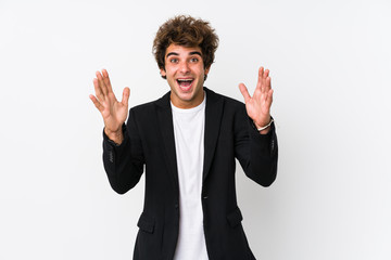 Young caucasian business man against a white background isolated receiving a pleasant surprise,...