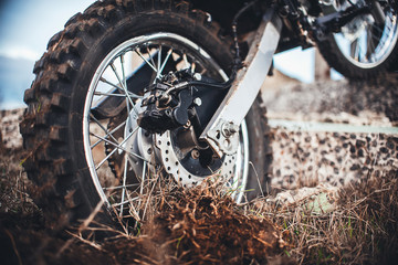 Action the wheel of an Enduro Motorcycle Hits an obstacle in the ground