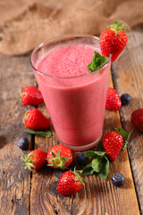 berry fruit smoothie on wood background